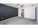 Spacious bedroom with gray accent wall and carpet at 14906 Imperial Purple Ln, Wimauma, FL 33598