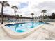 Community pool with plenty of lounge chairs for sunbathing at 650 Pinellas Point S Dr # 211, St Petersburg, FL 33705
