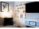 Living room with built-in shelving and a large TV at 650 Pinellas Point S Dr # 211, St Petersburg, FL 33705