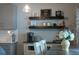 Farmhouse-style kitchen with floating shelves and coffee bar at 650 Pinellas Point S Dr # 211, St Petersburg, FL 33705