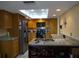 Bright kitchen with granite countertops, stainless steel appliances, and wood cabinets at 13936 Clubhouse Cir # 13936, Tampa, FL 33618