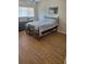Guest bedroom with laminate flooring and a brass bed frame at 13936 Clubhouse Cir # 13936, Tampa, FL 33618