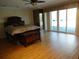 Main bedroom with wood floors and access to a deck at 13936 Clubhouse Cir # 13936, Tampa, FL 33618
