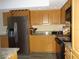 Modern kitchen with stainless steel appliances and light wood cabinets at 13936 Clubhouse Cir # 13936, Tampa, FL 33618