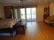 Main bedroom with wood floors and access to a deck at 13936 Clubhouse Cir # 13936, Tampa, FL 33618