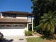 Two-story house with a double garage and well-maintained landscaping at 13936 Clubhouse Cir # 13936, Tampa, FL 33618