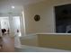 Upper hallway with doors to bedrooms and laundry at 13936 Clubhouse Cir # 13936, Tampa, FL 33618