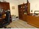 Home office with ample built-in shelving and wood flooring at 13936 Clubhouse Cir # 13936, Tampa, FL 33618