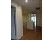 Light-toned hallway with wood flooring and doors to other rooms at 13936 Clubhouse Cir # 13936, Tampa, FL 33618