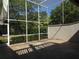 Spacious screened patio with tiled floor and lush green surroundings at 13936 Clubhouse Cir # 13936, Tampa, FL 33618
