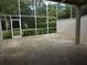 Spacious screened patio with a concrete floor and lush green backyard at 13936 Clubhouse Cir # 13936, Tampa, FL 33618