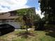 Two-story house with attached garage and palm tree at 13936 Clubhouse Cir # 13936, Tampa, FL 33618