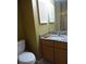 Small bathroom with granite countertop and wooden cabinets at 13936 Clubhouse Cir # 13936, Tampa, FL 33618