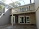 Back patio with elevated deck, sliding glass doors, and lush landscaping at 13936 Clubhouse Cir # 13936, Tampa, FL 33618