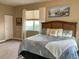 Large bedroom with king bed, beach decor, and plenty of natural light at 253 Ashley Ct, Dunedin, FL 34698