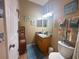 Bathroom with wood vanity, decorative accents, and tile flooring at 253 Ashley Ct, Dunedin, FL 34698