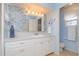 Bathroom with white vanity, light blue walls, and mosaic tile at 176 Philadelphia Lot 5 Blvd, Palm Harbor, FL 34684