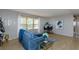 Living room featuring a blue sectional sofa, wood floors, and large artwork at 176 Philadelphia Lot 5 Blvd, Palm Harbor, FL 34684