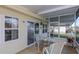 Screened porch with glass-top table and chairs at 176 Philadelphia Lot 5 Blvd, Palm Harbor, FL 34684