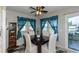 Cozy dining area with dark wood table and teal curtains at 176 Philadelphia Lot 5 Blvd, Palm Harbor, FL 34684