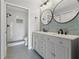 Modern bathroom with double vanity, hex floor tile, and walk-in shower at 1662 Seascape Cir # 205, Tarpon Springs, FL 34689