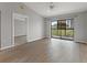 Open living room showcasing wood-look floors and access to another room at 1662 Seascape Cir # 205, Tarpon Springs, FL 34689