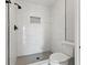 Walk-in shower with marble-look tile and hexagonal floor tile at 1662 Seascape Cir # 205, Tarpon Springs, FL 34689