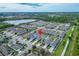 Expansive aerial view showcasing the community, nearby lake, and well-maintained landscaping at 707 Winterside Dr, Apollo Beach, FL 33572