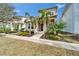 Home with an inviting front entrance, palm trees, and lush landscaping at 707 Winterside Dr, Apollo Beach, FL 33572