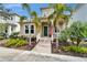 Beautiful home with an inviting porch, tropical landscaping, and sunny curb appeal at 707 Winterside Dr, Apollo Beach, FL 33572