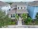 Attractive home with a well-manicured lawn, tall palm trees, and a charming covered porch at 707 Winterside Dr, Apollo Beach, FL 33572