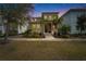 Charming two-story home with landscaped front yard and welcoming front porch at dusk at 707 Winterside Dr, Apollo Beach, FL 33572