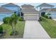 Home exterior featuring a spacious driveway, mature landscaping, and a cozy front porch at 707 Winterside Dr, Apollo Beach, FL 33572