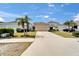 Home exterior with a long driveway leading to a two-car garage and well-maintained lawn at 707 Winterside Dr, Apollo Beach, FL 33572