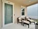 Charming front porch with comfortable seating, perfect for relaxing and enjoying the outdoors at 707 Winterside Dr, Apollo Beach, FL 33572