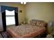 Charming bedroom with floral bedding and a ceiling fan at 3411 Landover Blvd, Spring Hill, FL 34609