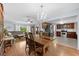 Bright dining room features a large wooden table and a chandelier, open to the kitchen at 349 Lantana Ave, Sarasota, FL 34243