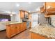 Kitchen features granite countertops, wood cabinets, and stainless steel appliances at 5621 Moog Rd, New Port Richey, FL 34652