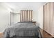 Bright bedroom with gray bedding and wood floors at 5621 Moog Rd, New Port Richey, FL 34652