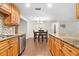 Modern kitchen with granite countertops, stainless steel appliances, and wood cabinets at 5621 Moog Rd, New Port Richey, FL 34652