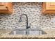 Modern kitchen sink with black faucet and granite countertop at 5621 Moog Rd, New Port Richey, FL 34652