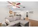 Cozy living room with light gray sectional sofa and wood floors at 5621 Moog Rd, New Port Richey, FL 34652