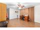 Home office with wood floors, built-in desk and neutral color scheme at 5621 Moog Rd, New Port Richey, FL 34652