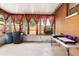 Bright sunroom with red curtains and a view of the backyard at 5621 Moog Rd, New Port Richey, FL 34652
