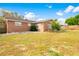 Backyard of a home with a large grassy area and a wooden fence at 5621 Moog Rd, New Port Richey, FL 34652