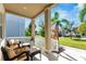 Spacious covered porch with seating and a view of the backyard at 707 Winterside Dr, Apollo Beach, FL 33572
