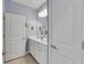 Double vanity bathroom with light gray walls and white cabinets at 707 Winterside Dr, Apollo Beach, FL 33572