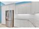 Stainless steel refrigerator built into white cabinetry in a modern kitchen at 707 Winterside Dr, Apollo Beach, FL 33572