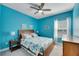 Coastal-themed bedroom with a queen bed and ceiling fan at 707 Winterside Dr, Apollo Beach, FL 33572