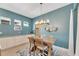Bright dining area with a rustic wooden table and modern chandelier at 707 Winterside Dr, Apollo Beach, FL 33572